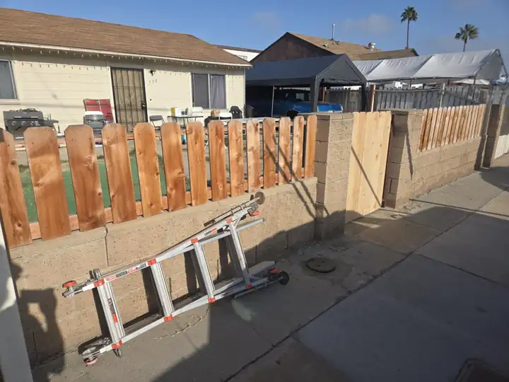 New wood fence on block wall