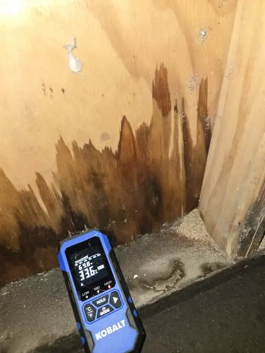 Water damage at the base of a wall